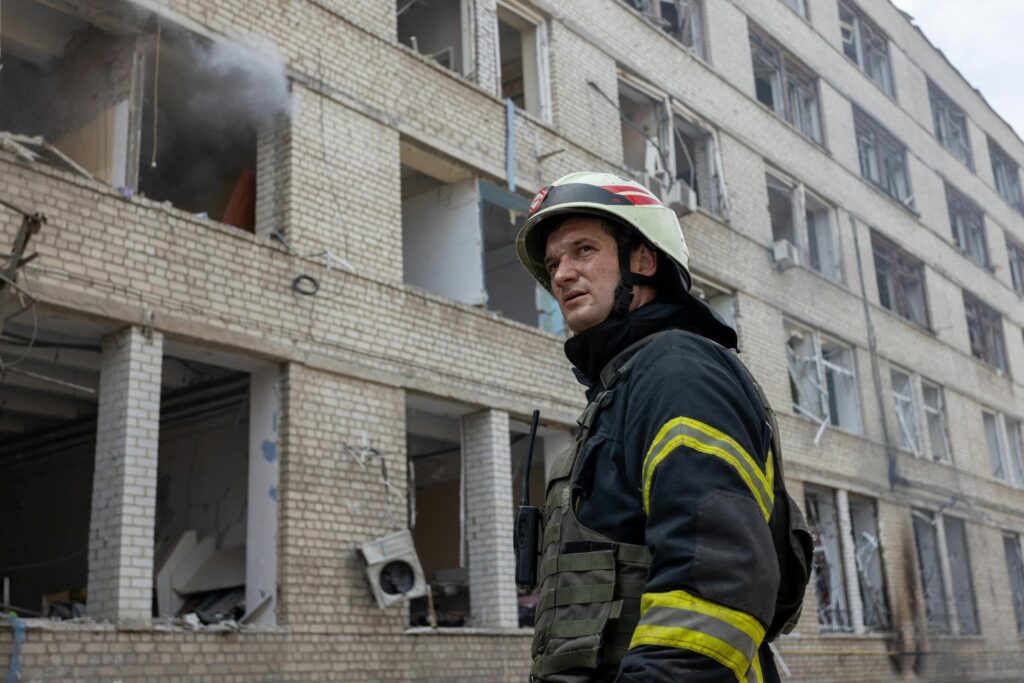 image of a fire officer outside a damaged building
