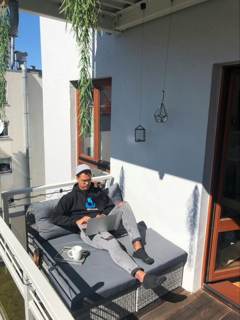 image of a remote worker in his balcony working