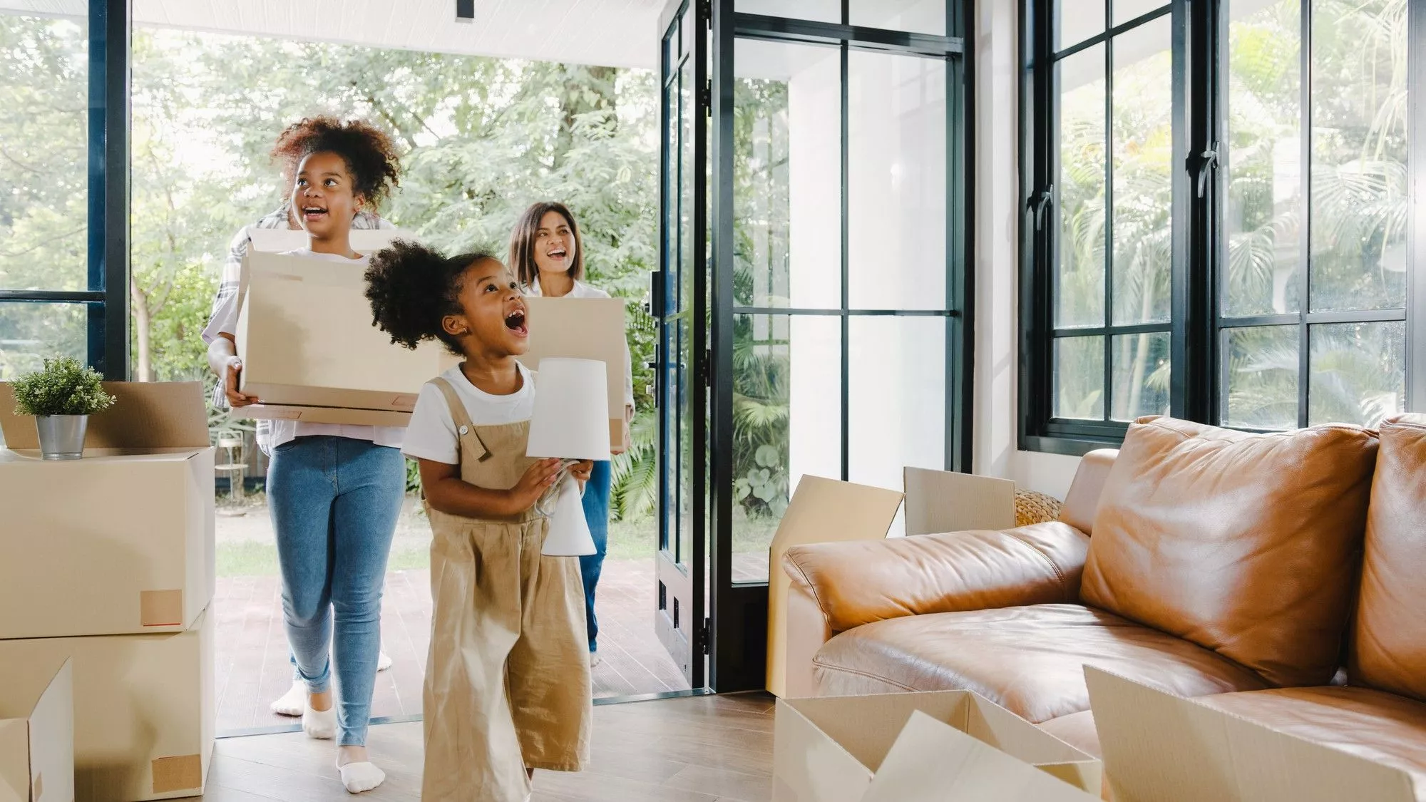 Image Of A Mother And Her Two Daughters Moving Into An Apartment With Boxes In Thier Hands | Home Insurance For Apartments | HMD Insurance