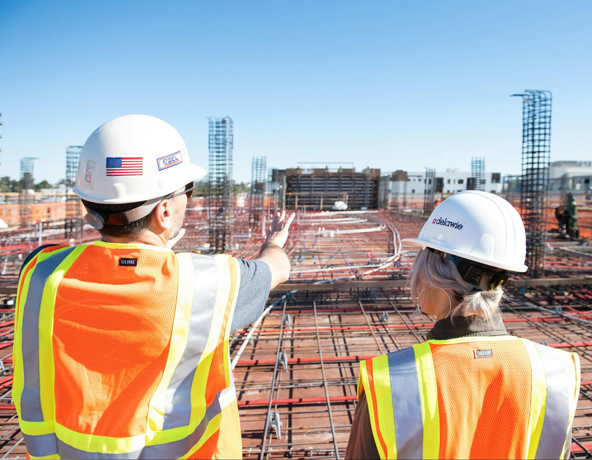 image of constructors surveying an uncompleted buillding