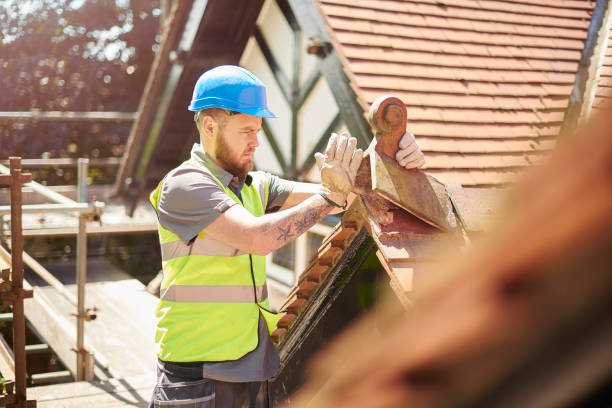 a builder or roofer is removing a finial on a roof of a period property