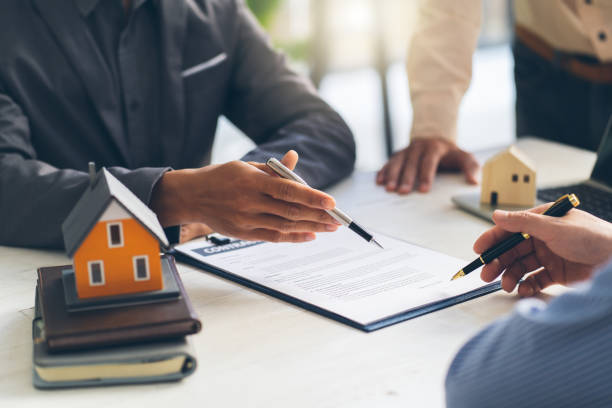 Real estate agent talked about the terms of the home purchase agreement and asked the customer to sign the documents to make the contract legally, Home sales and home insurance concept.