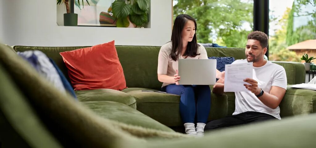man and woman checking insurance papers at home
